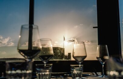 A table set with wine glasses facing the beach view from Port Local Bistro